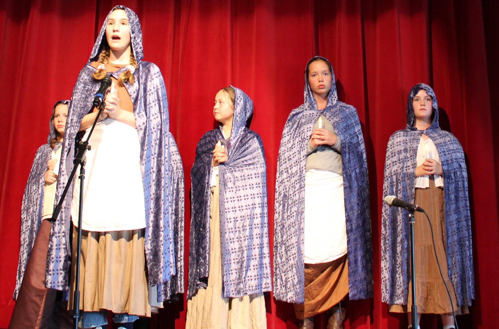 Wondall Heights students performing in blue cloaks in The Book of Once Uponers